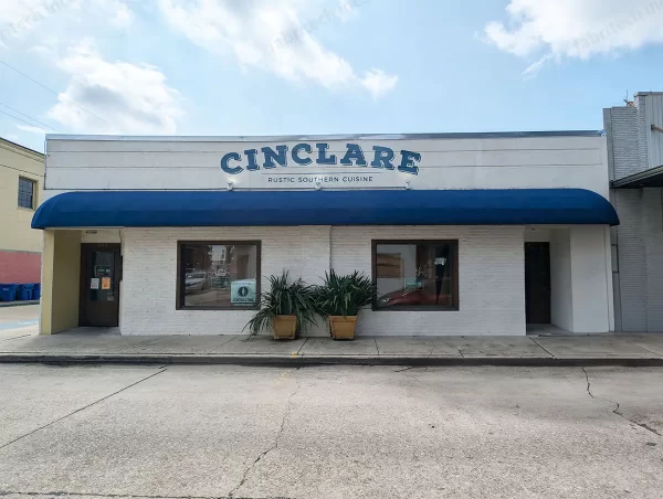 Blue dome awning with straight valance over Cinclare storefront