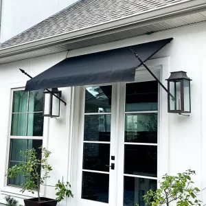 Black fabric venetian awning with decorative spears installed over French doors